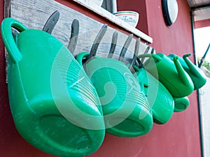 Watering cans hanging on horsehoes