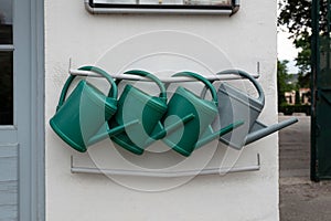 Watering cans hanging on a wall