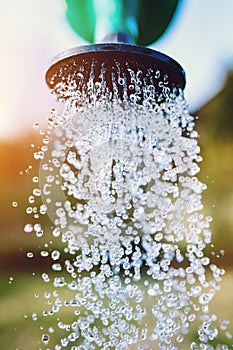 Watering garden. Water pouring from the pot