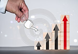 Watering the graph on the wood blog, as well as the firm finance and money saving investment concept. Growing Money is a notion