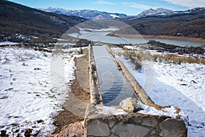 Watering hole by a lake in the snowy mountains