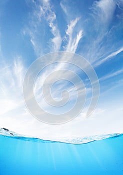 Waterline with sea underwater and blue sunny sky