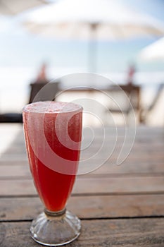 Watermellon juice is standing on the wooden table