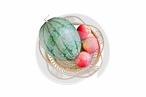 Watermelon and apples in a basket on isolated white background