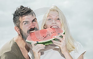 Watermelon as a symbol of summer, unity and oneness. Portrait of happy couple enjoying watermelon on summer holiday