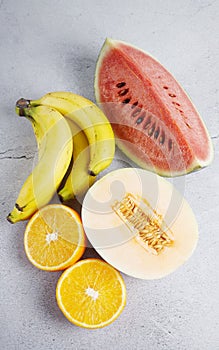 Watermelon, Bananas, Oranges, Cantaloupe on white background. Organic fruit.