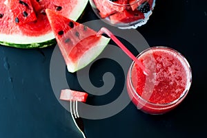 Watermelon, blackberry smoothies with straw and pieces of fruit