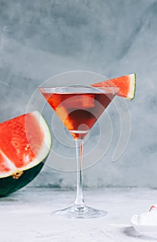 Watermelon cocktail in martini glass on the table. Refreshing drink