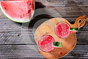 Watermelon cocktail on a wooden table.