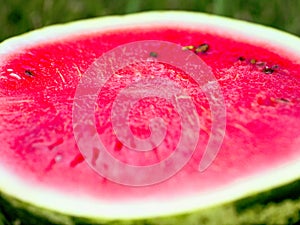 Watermelon cut along the close-up. Red, juicy, ripe. Summer berries and fruits. Summer. Healthy eating concept.