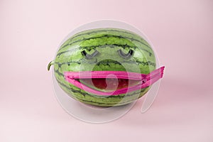 Watermelon with fake eyelashes and zipper mouth. On trendy soft pink background