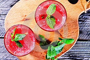 Watermelon Mojito with Watermelon Garnish on wooden table