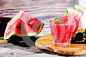 Watermelon Mojito with Watermelon Garnish on wooden table