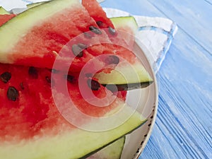 watermelon piece organic summer nature seasonal refreshment of a plate on a blue wooden background