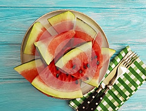 Watermelon pieces seasonal on a blue wooden background organic