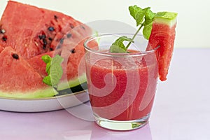 Watermelon pulp smoothie. Delicious red sliced watermelon on a plate. Stock of fiber and fructose. Summer food concept