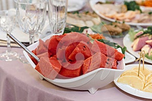 Watermelon red slices on a platter.