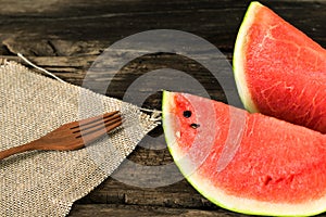 the watermelon on a rustic wooden table background with wood for