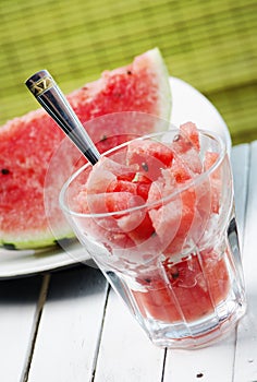 Watermelon slice and melon sweet dessert smoothie on white table. Summertime refreshment detox food. Summer fruit cold slush