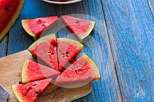 Watermelon slice popsicles on a blue rustic wood background