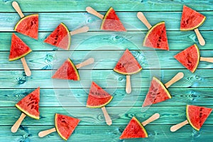 Watermelon slice popsicles on blue wood background, fresh fruit concept