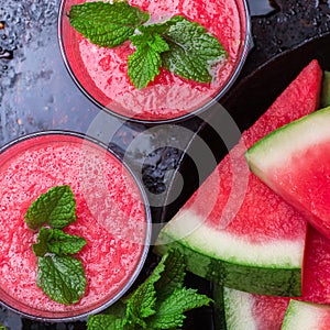 Watermelon slices drink smoothie with mint on grunge table