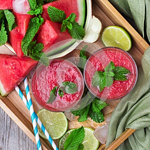 Watermelon slices and drink smoothie on rustic wooden table