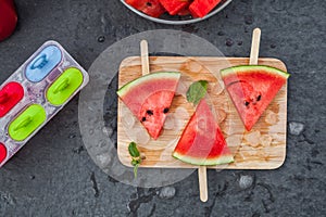 Watermelon slices on wooden stick with lime