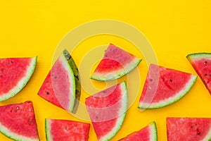 Watermelon slices on yellow background with copy space, summer fruit concept