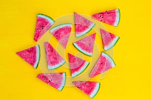 Watermelon slices on yellow background, summer fruit concept