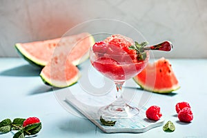Watermelon sorbet or granita, refreshing summer dessert with strawberries photo