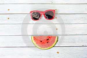 Watermelon and sunglasses on blue wooden background summer holidays vacation concept