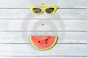 Watermelon and sunglasses on blue wooden background summer holidays vacation concept