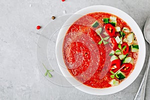 Watermelon and Tomato Gazpacho in white bowl. Top view.