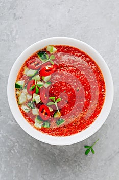 Watermelon and Tomato Gazpacho in white bowl. Top view.