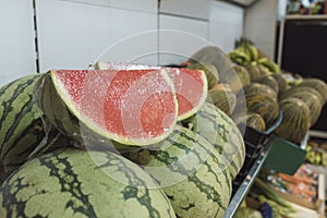 Watermelons cut and placed for sale in the greengrocer`s photo