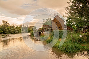 Watermill on the river sunset