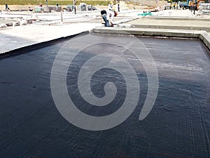 Waterproof coatings applied on flat roof concrete surfaces.