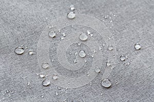 Waterproof droplets on fabric. Grey Canvas Polyester texture synthetical for background. Black polyester textile backdrop for