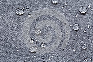 Waterproof droplets on fabric. Grey Canvas Polyester texture synthetical for background. Black polyester textile backdrop for