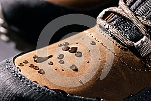 waterproof leather boots. closeup of rain drops on water resistant footwear. weatherproof clothing