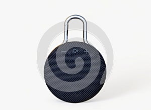 Waterproof round black speaker with carabiner. Digital music and sound concept. Mini, suitable for travel. Modern