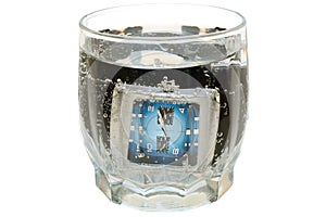 Waterproof watch in glass with water.