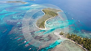the waters of an ocean with a sandy island in the middle photo