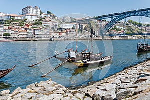 Waters of river Douro with riverboats full of wooden barrels with port wine, old boats from local wineries