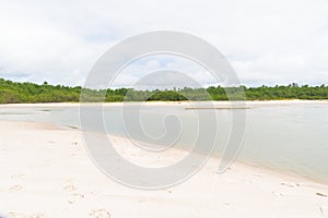 Waters from a river that flows into the sea. white sand on the beach. Preserved environment