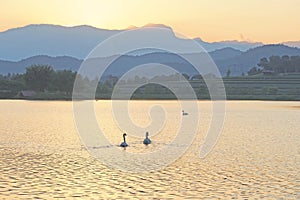 Waterscape with mountain background on sunset