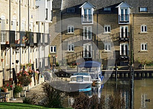 Waterside Apartments with Balconies and Boats in water Cambridgeshire UK..