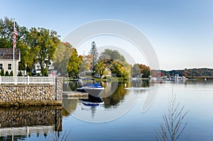 Waterside Houses and Boats Moored to Wooden Jetties under an Autumnal Clear Sky