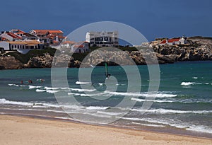 Watersports at the coast in front of the historic houses of peninsula Baleal, Portugal